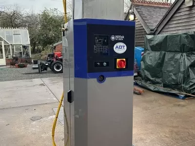 Reconditioned Delta booster pressure washer positioned outside on a pallet prior to installation at a factory in Measham.